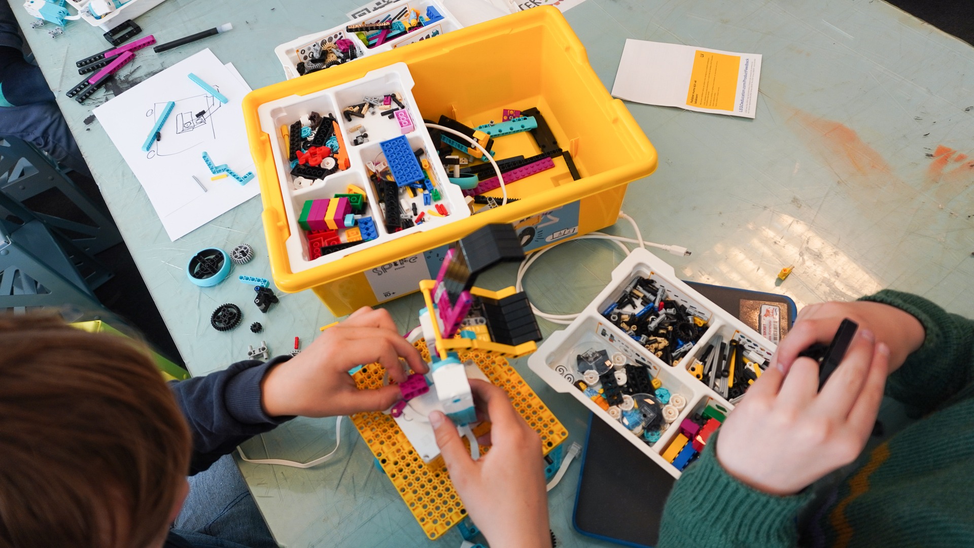 Fra ovenpå: to elever arbejder med LEGO Spike